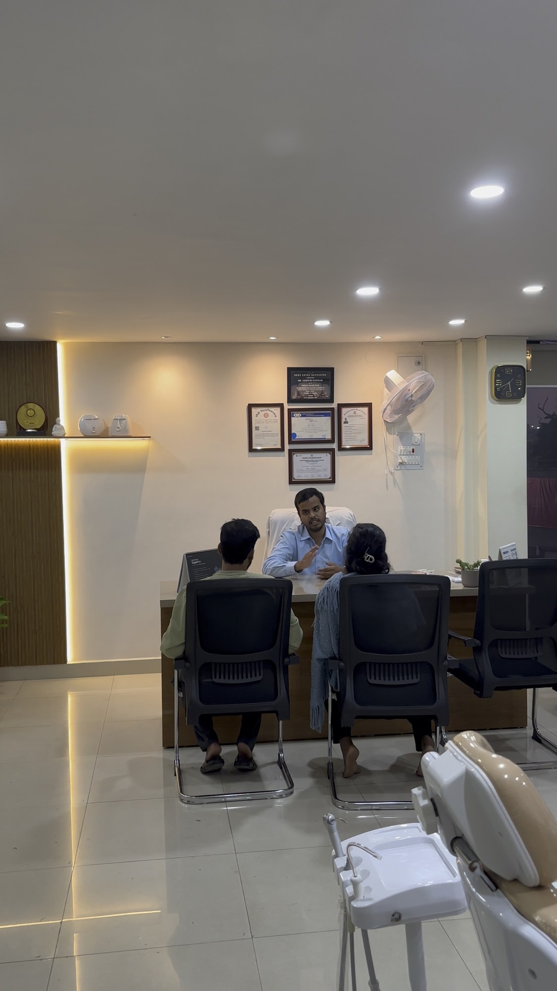 Dr. Akhouri Sanskar speaking with patients at the consultation desk at Enamel Dental, Argora Chowk.