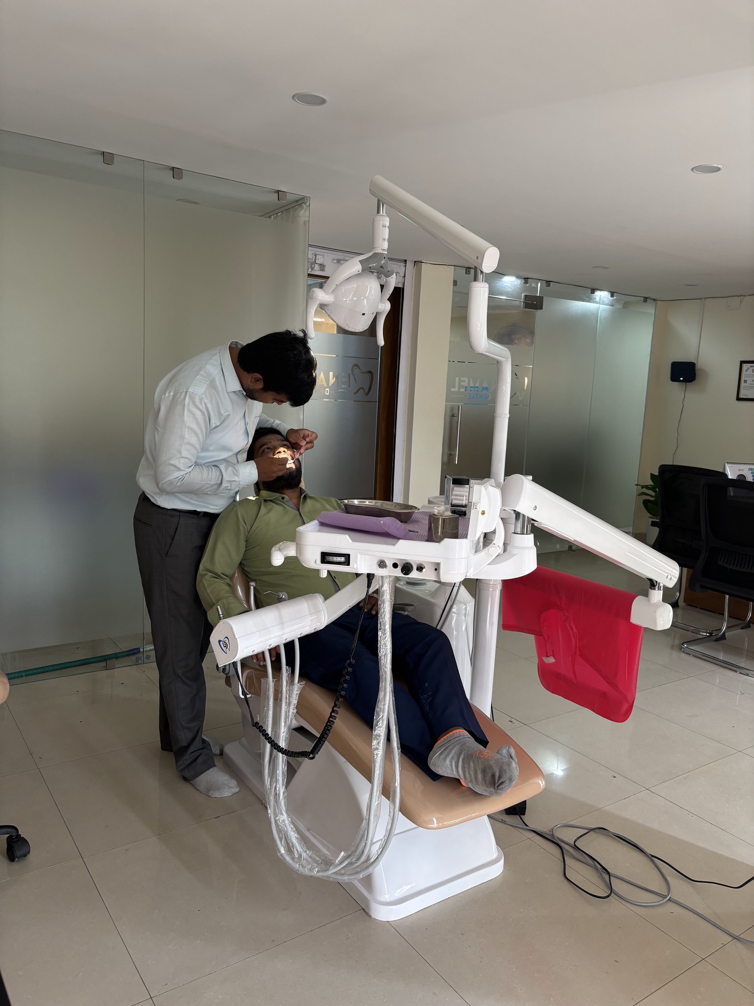 Dr. Akhouri Sanskar examining a patient in the dental chair at Enamel Dental, Argora Chowk.